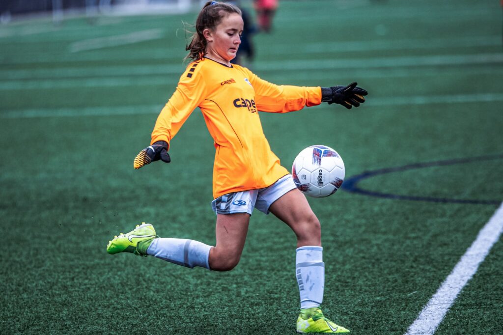 Young rush soccer player kicking the ball