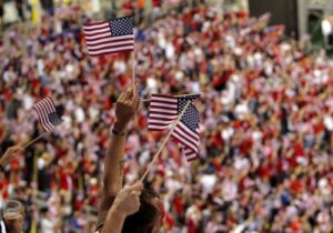 USA fans wave American flags in the crowd at a U.S. Women’s National Soccer Team match